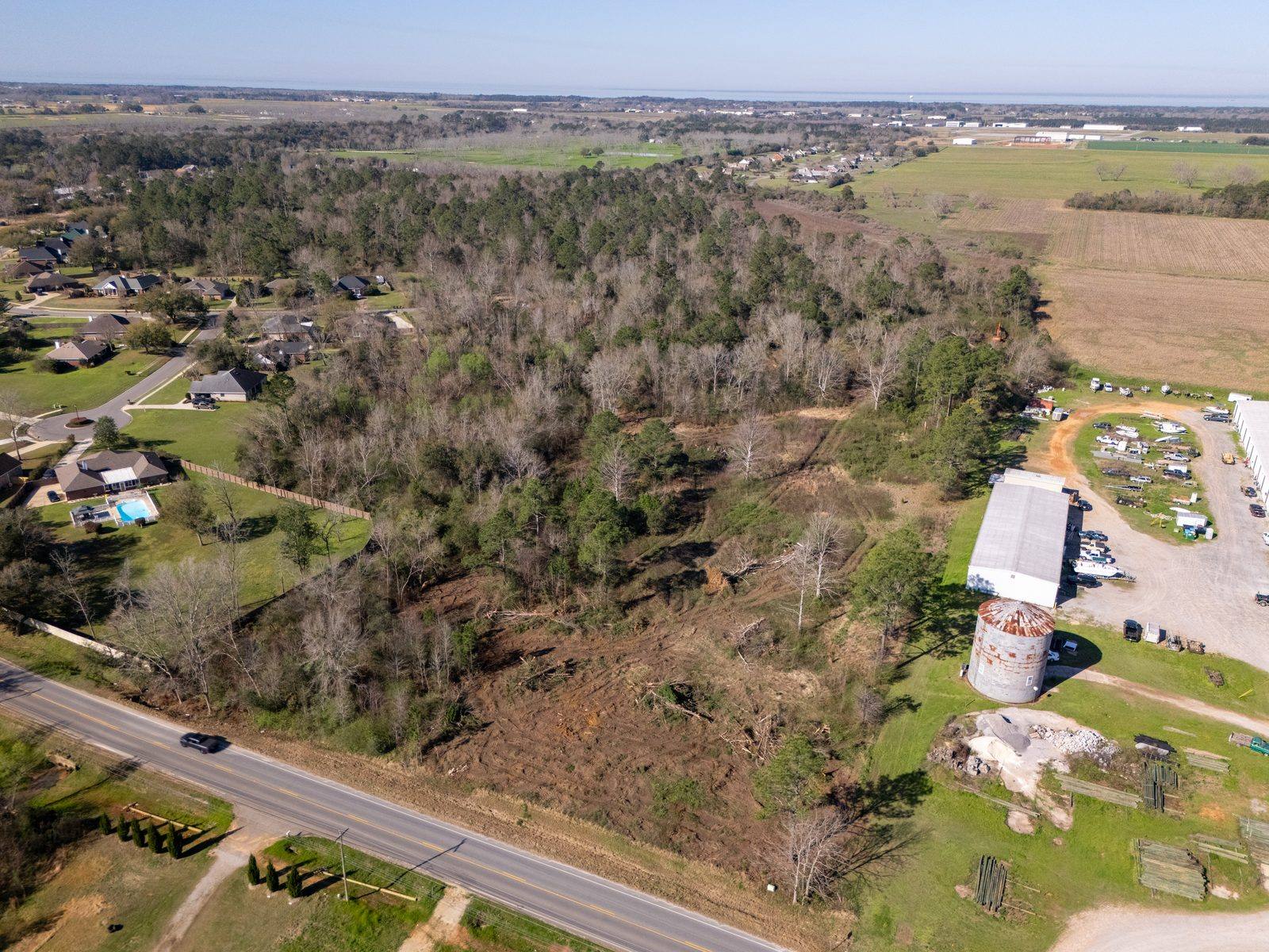 Raw, overgrown Gaineswood site before H&W Services cleared and graded it